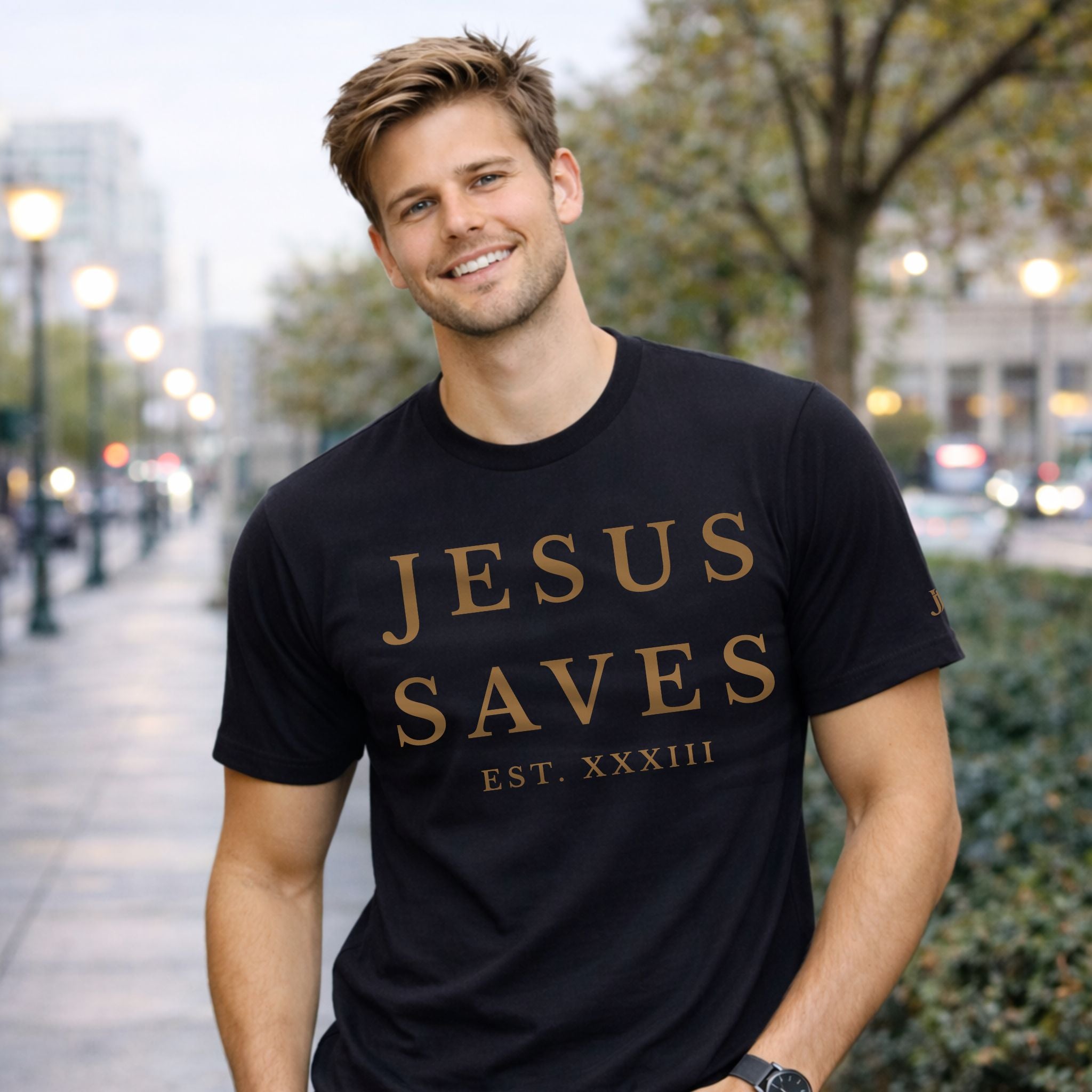 Man wearing a black t-shirt with 'JESUS SAVES' text on a city street.