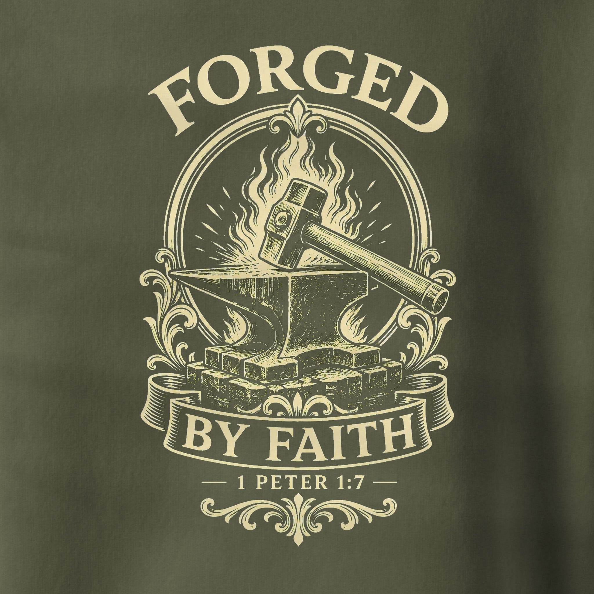 Close-up of a dark olive green fabric with a cream-colored graphic print featuring an anvil, hammer, flames, and the text 'FORGED BY FAITH' and '1 PETER 1:7'.