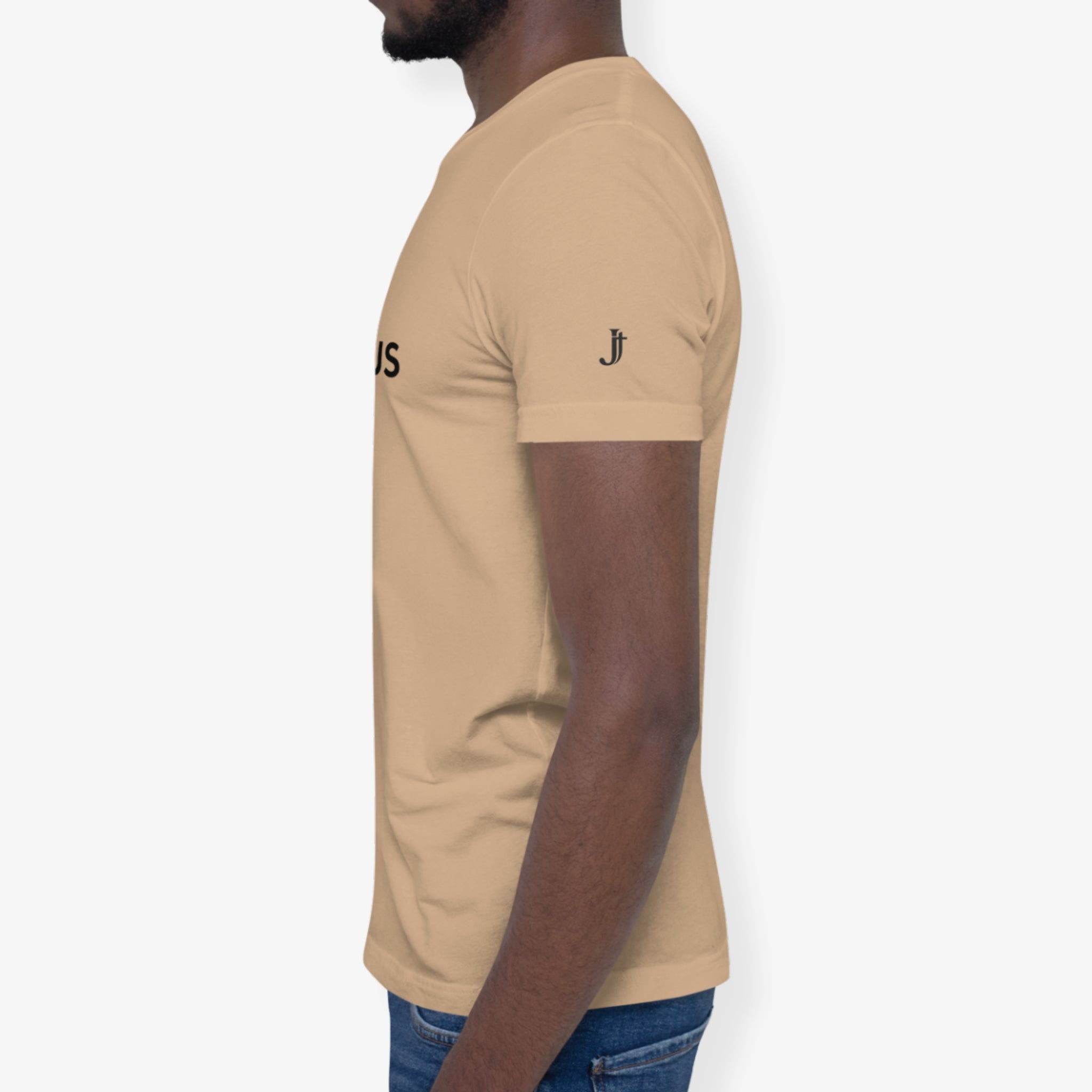 Person wearing a beige t-shirt with logos on the sleeves against a white background
