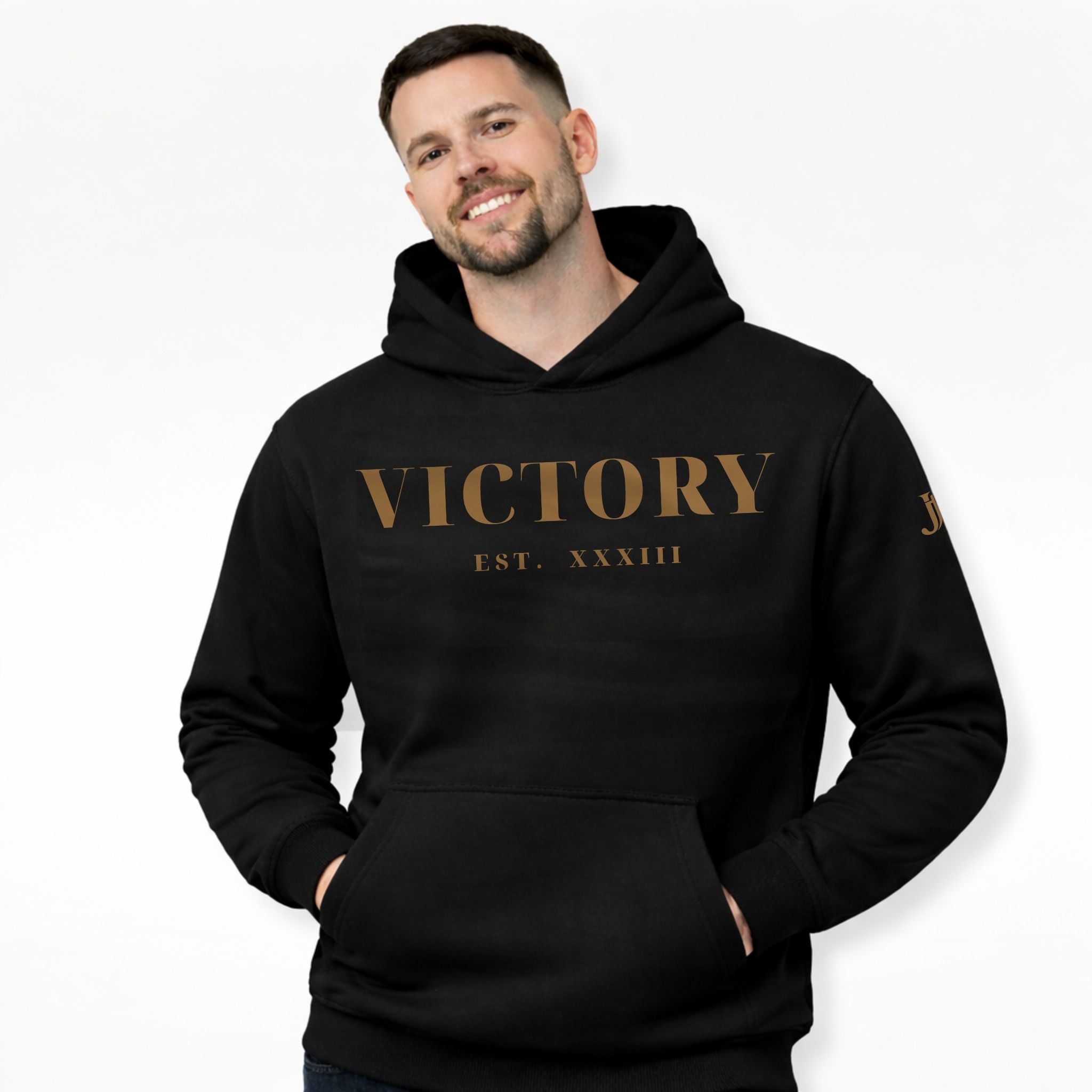 Man wearing a black hoodie with 'VICTORY EST. XXXIII' text on a white background