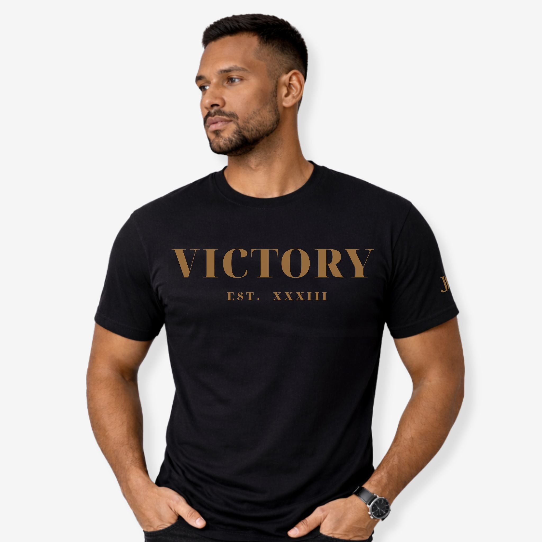 Man wearing a black t-shirt with 'VICTORY EST. XXXIII' text on a white background