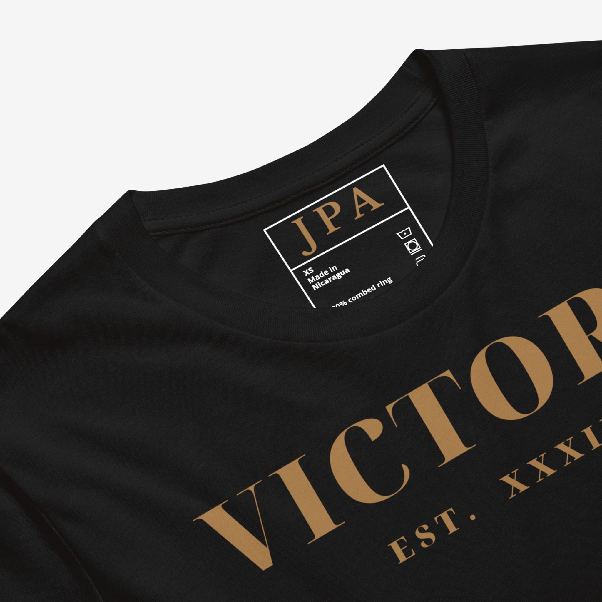 Black t-shirt with gold text and a visible brand label on a light gray background