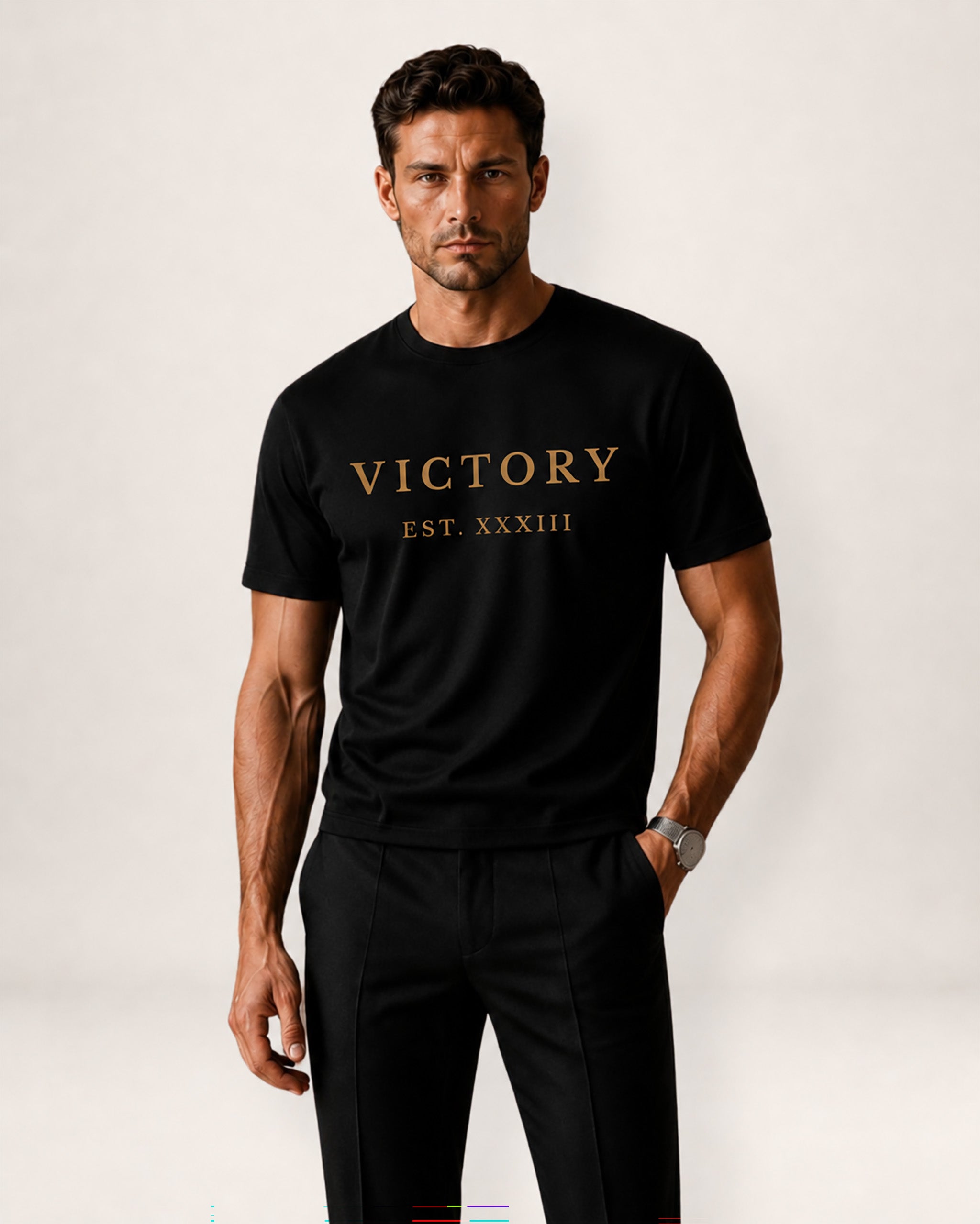 Man wearing a black t-shirt with 'VICTORY EST. XXXIII' text on a white background