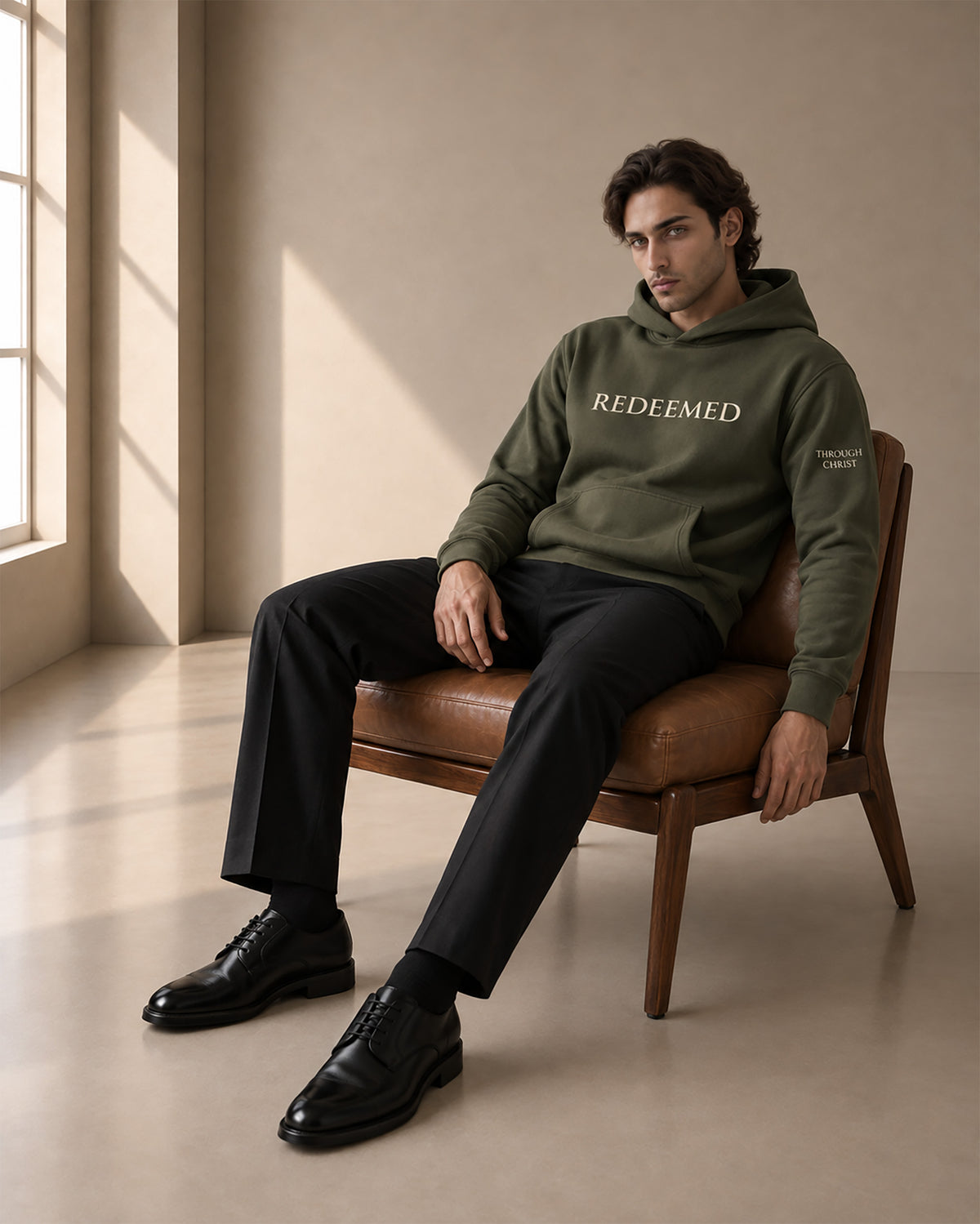 man sitting in chair _LIFESTYLE_REDEEMED_cypress_hoodie_JPG