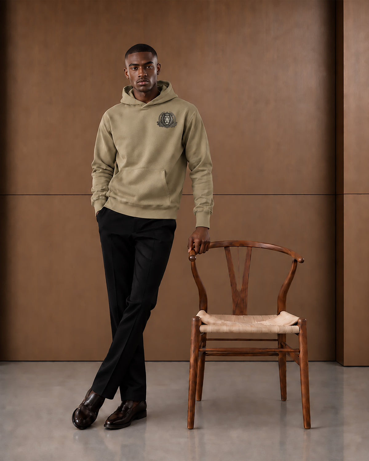 Lifestyle image of the Strong & Courageous sand hoodie, styled as part of the Jesus Passion Apparel Statement Collection.