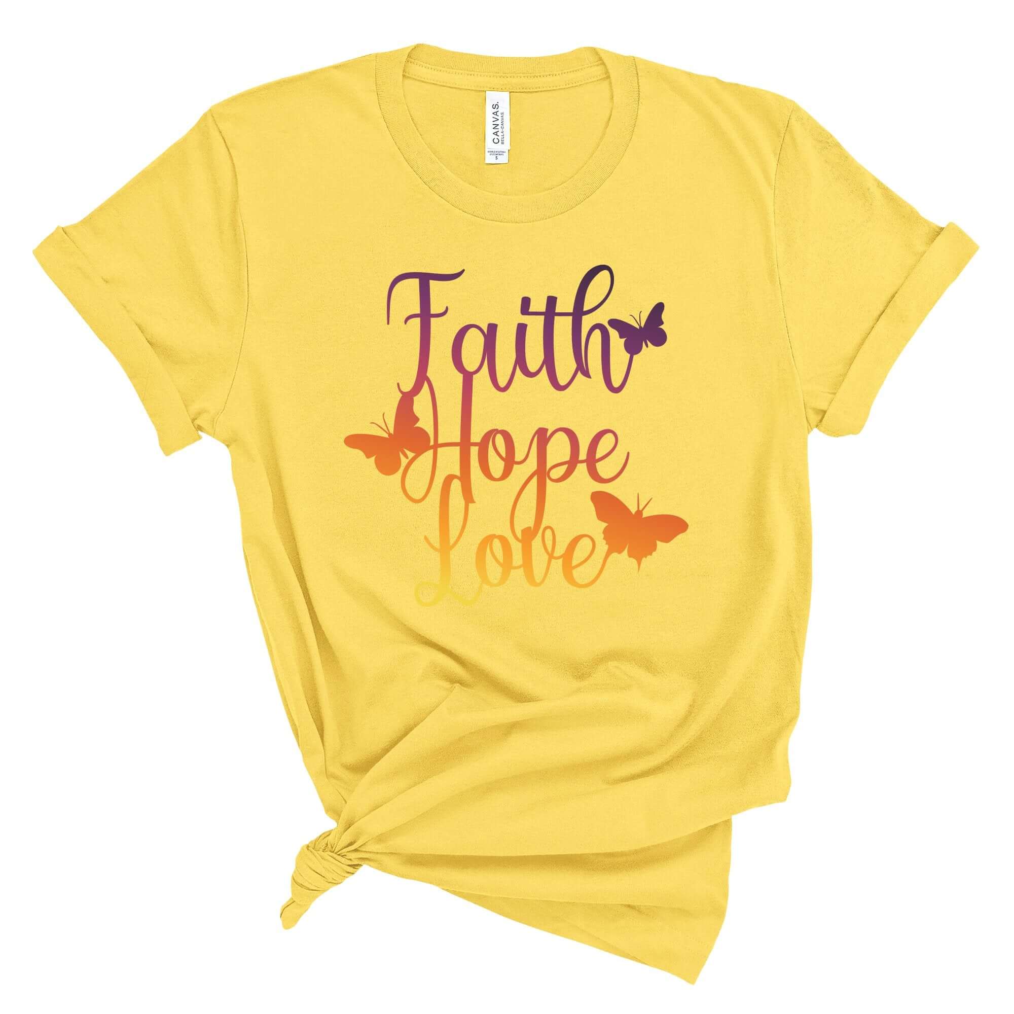 T-Shirts & TopsEmbrace a positive message with this vibrantly colored "Faith Hope Love" T-shirt, adorned with elegant butterflies. The rich gradients and inspirational words provide a daily dose of motivation, perfect for casual wear or as a thoughtful gi