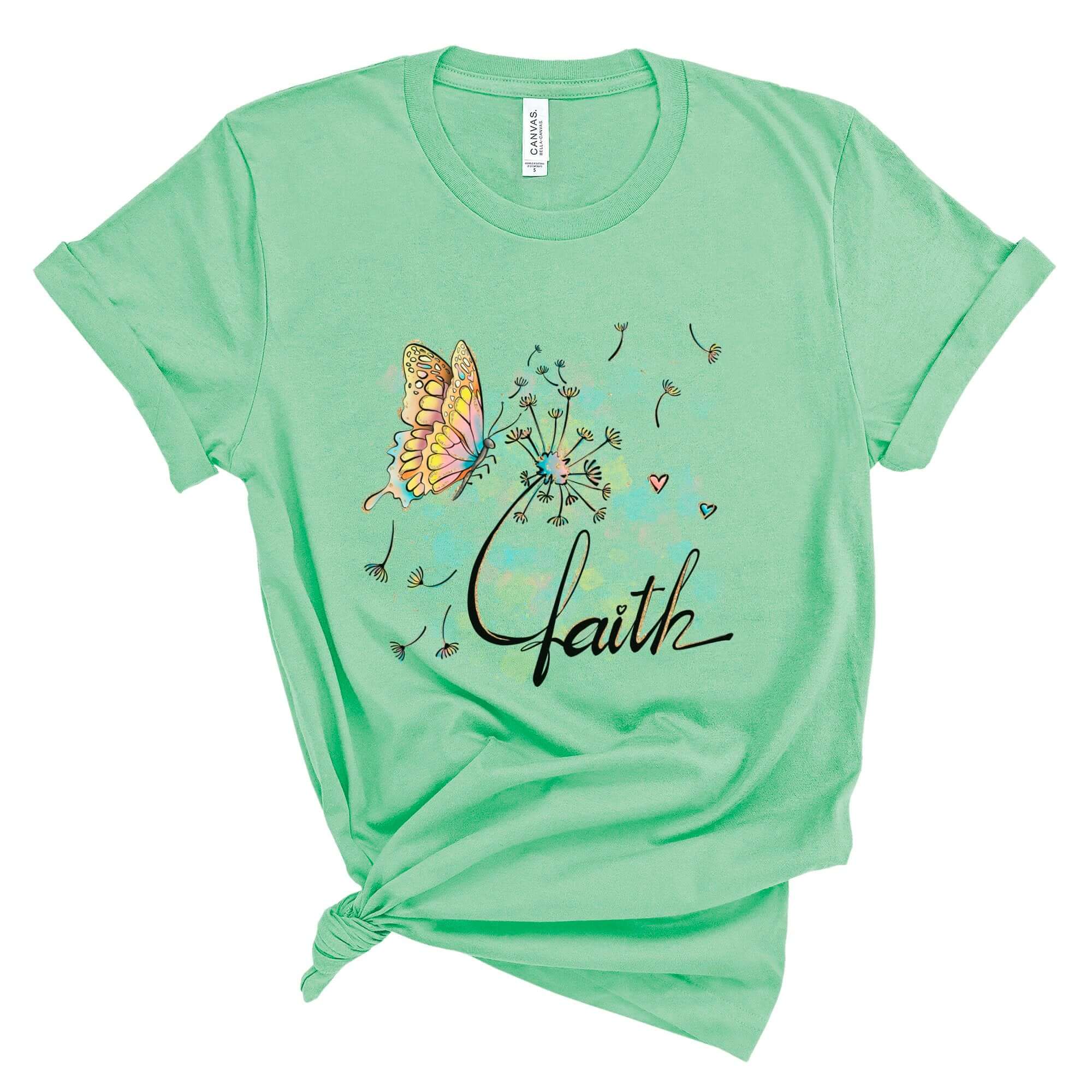 T-Shirts & TopsElevate your wardrobe with this beautifully artistic T-shirt featuring a delicately illustrated butterfly and dandelion with whimsical watercolor accents. The word "faith" is elegantly scripted, adding a touch of inspiration to your day. Pe