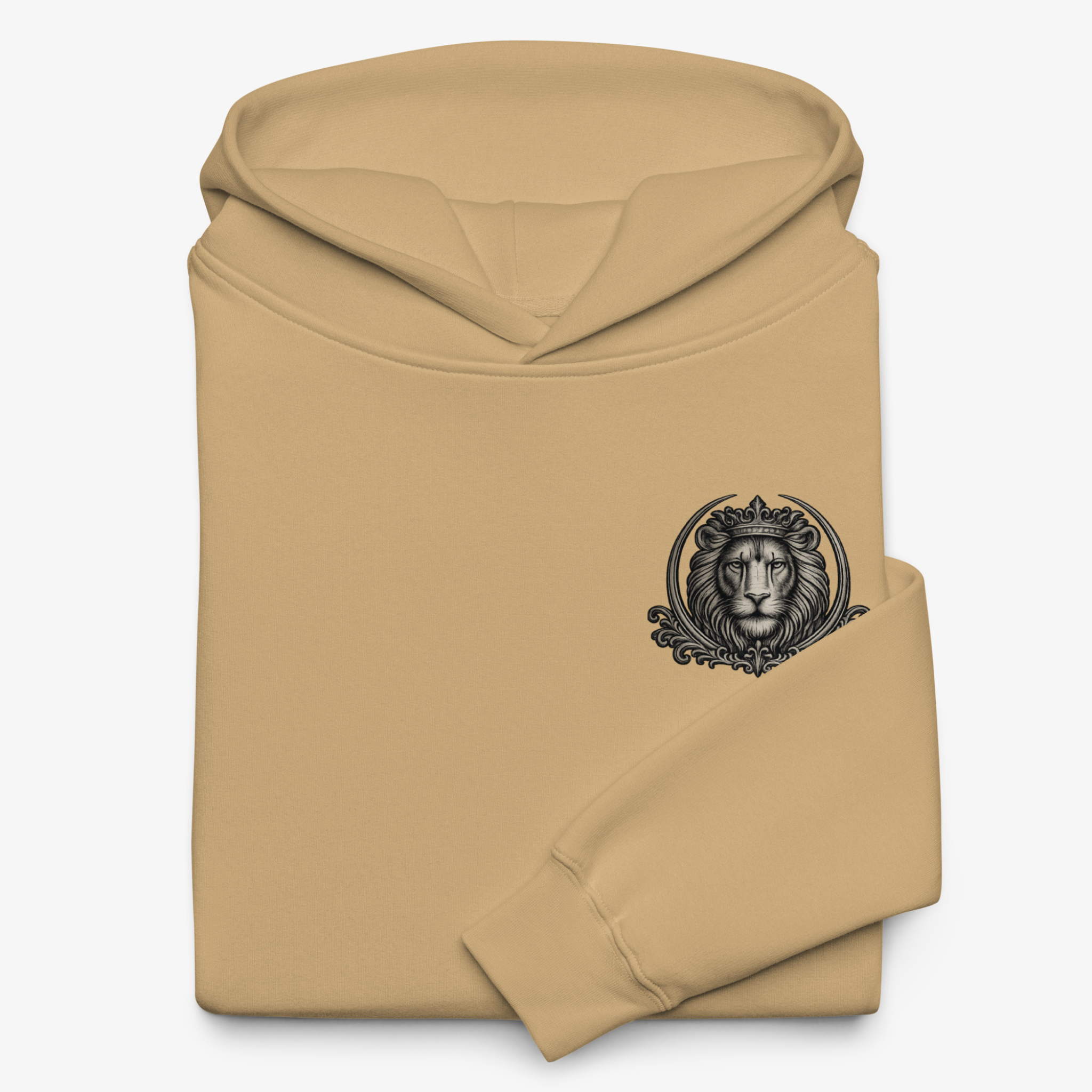 A folded tan hoodie with a black graphic of a lion's head inside an ornate circular frame on the chest, shown against a light gray background.