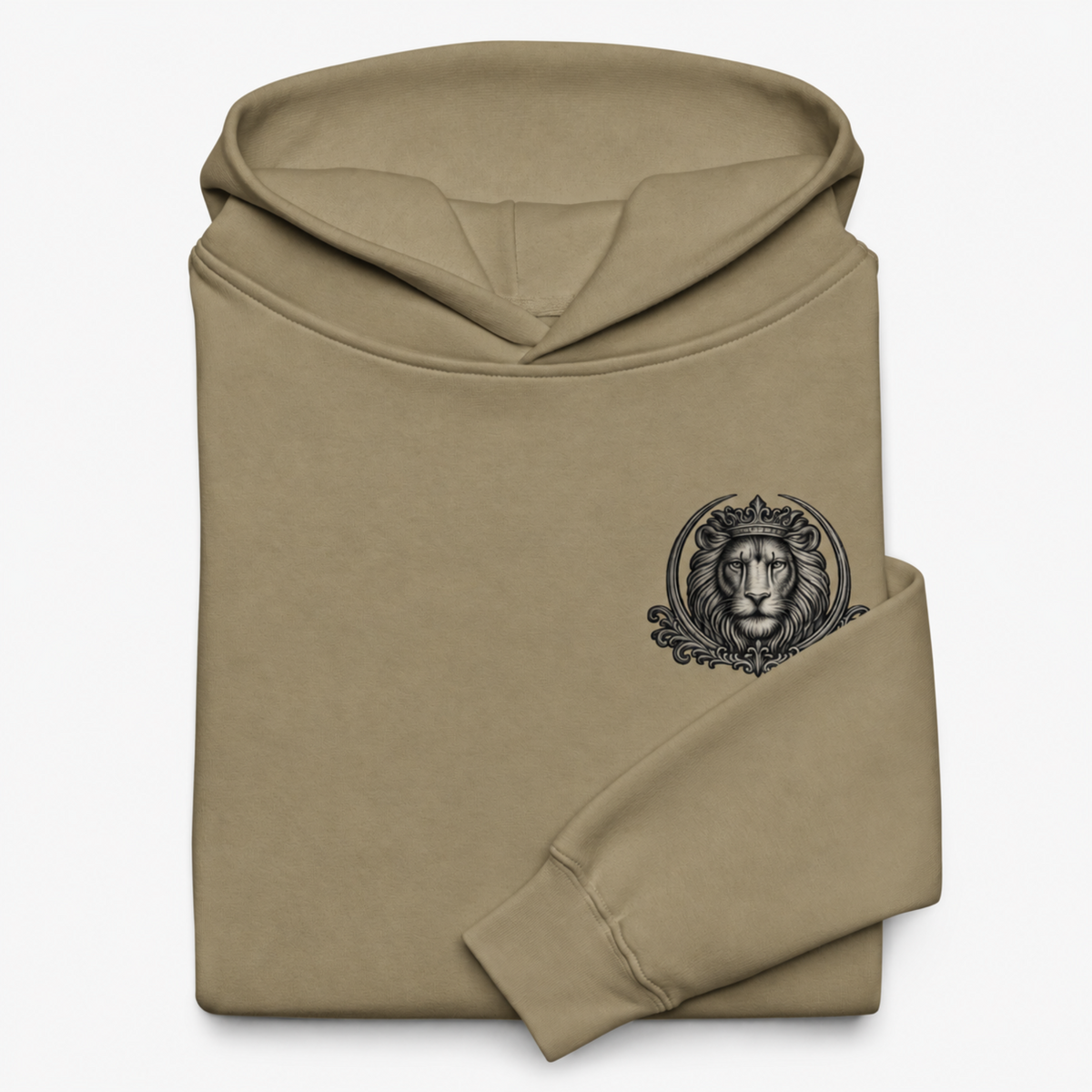 Folded Strong & Courageous sand hoodie on white, revealing the lined hood, ribbed cuff and black crowned lion chest emblem.