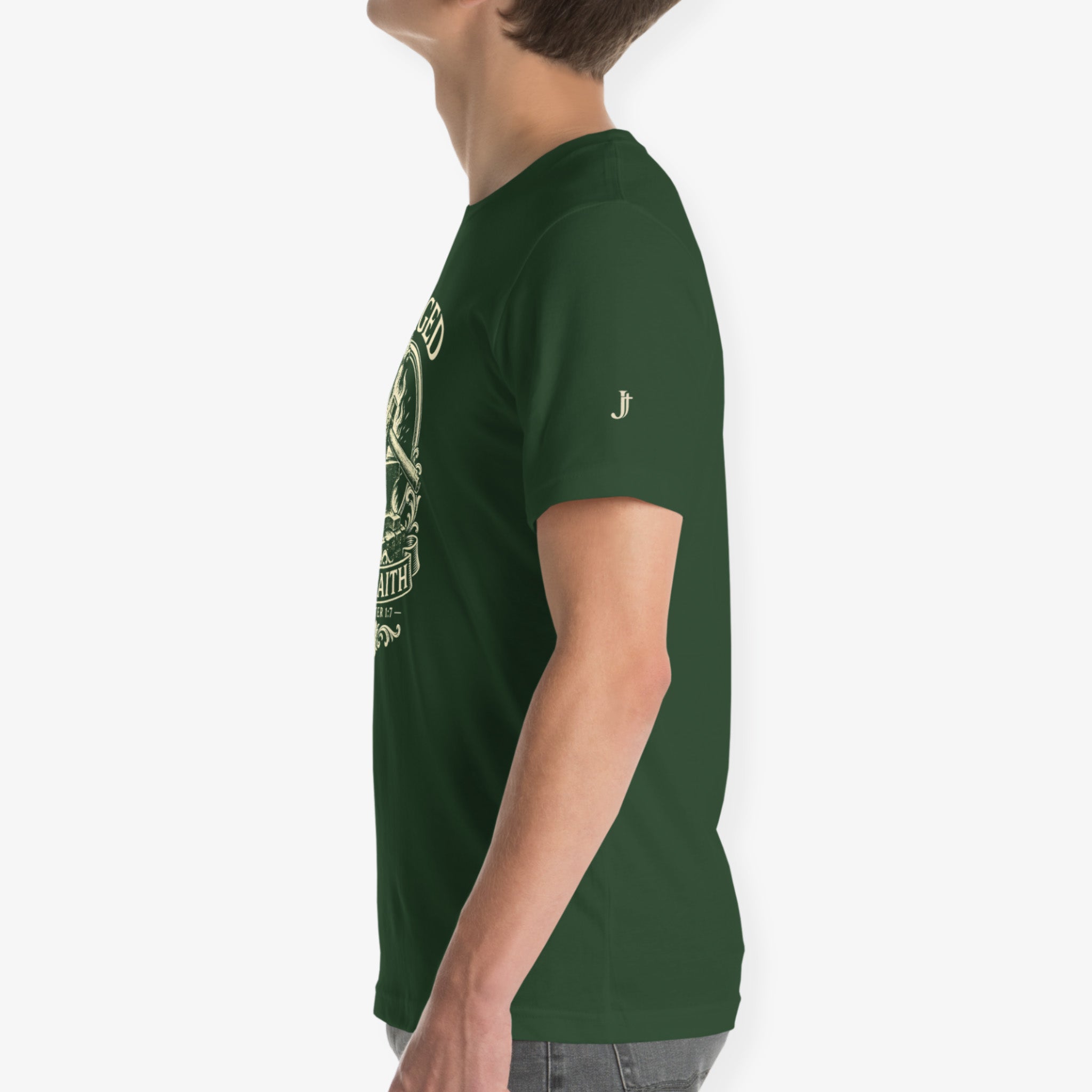 A side-profile view of a person wearing a dark green short-sleeve t-shirt with a light green graphic print on the front and a small white embroidered logo on the sleeve, set against a plain light gray background.