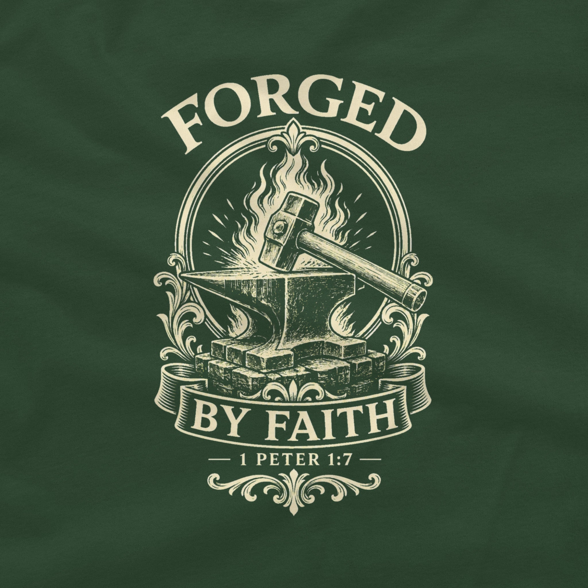 A close-up of a dark green fabric surface featuring a cream-colored graphic print with the words 'FORGED BY FAITH' and '1 PETER 1:7' surrounding an anvil, hammer, and flames.
