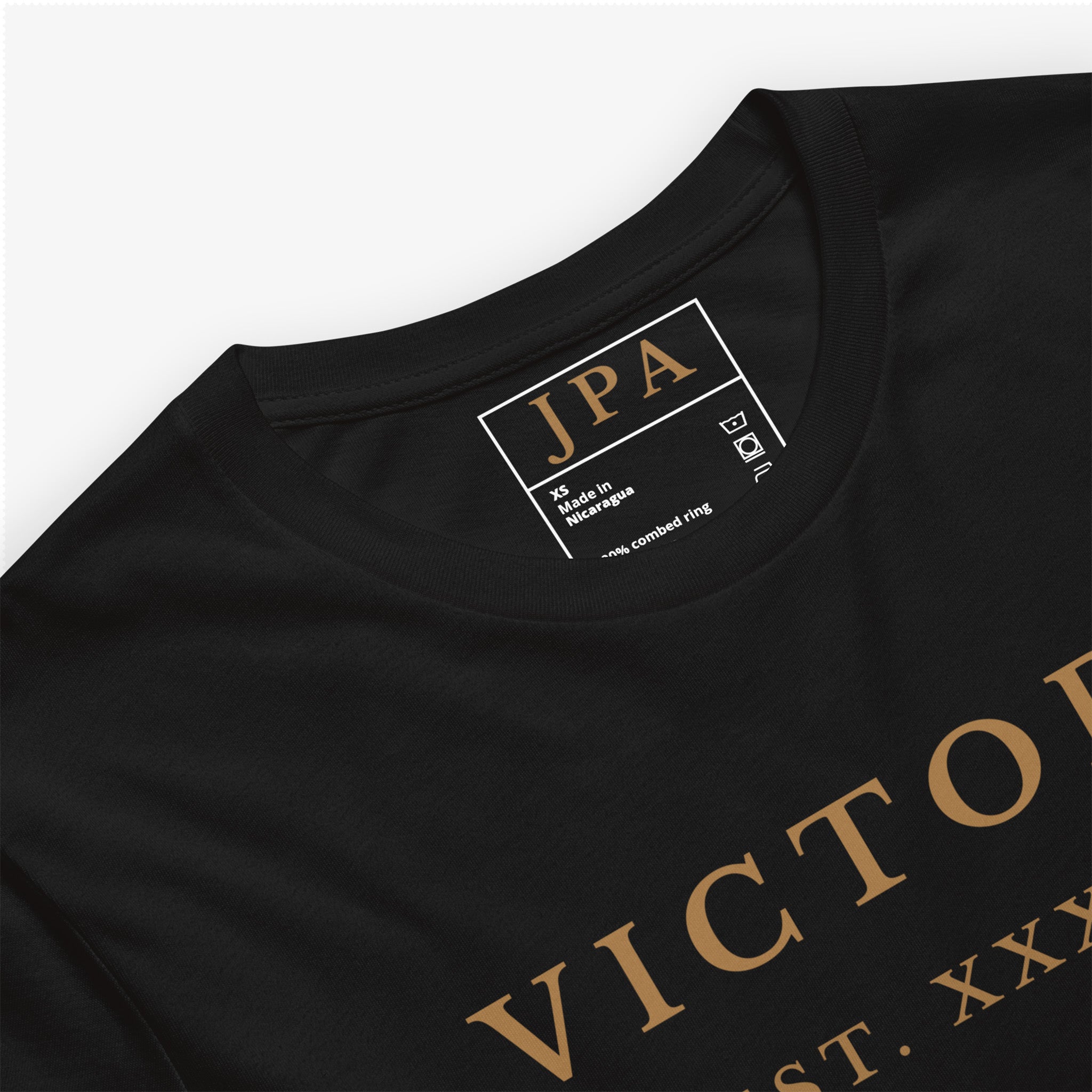 Black t-shirt with gold text and a visible brand label on a white background
