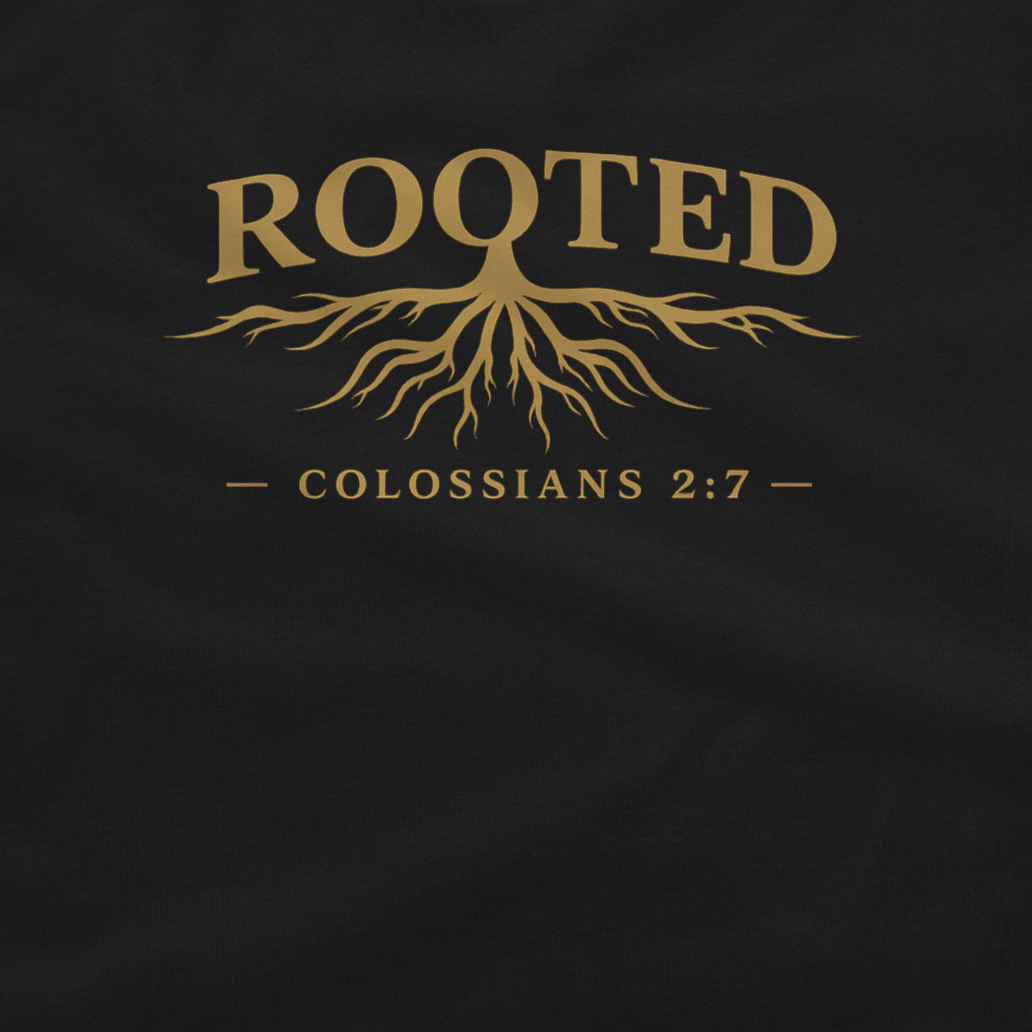 A close-up of a black garment featuring a gold graphic print with the word 'ROOTED' above a tree root design and the text 'COLOSSIANS 2:7' below.