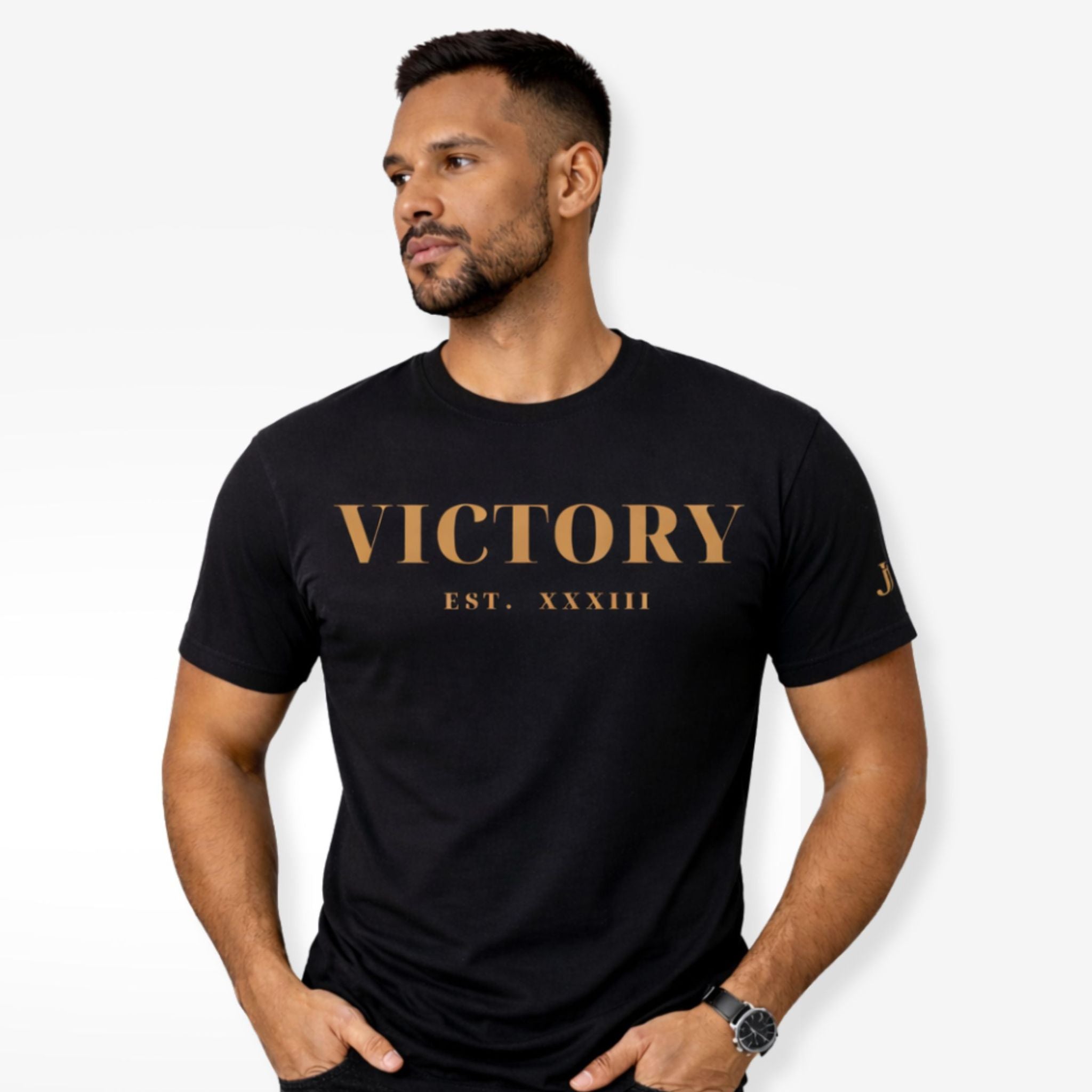 Man wearing a black t-shirt with 'VICTORY EST. XXXIII' text on a white background