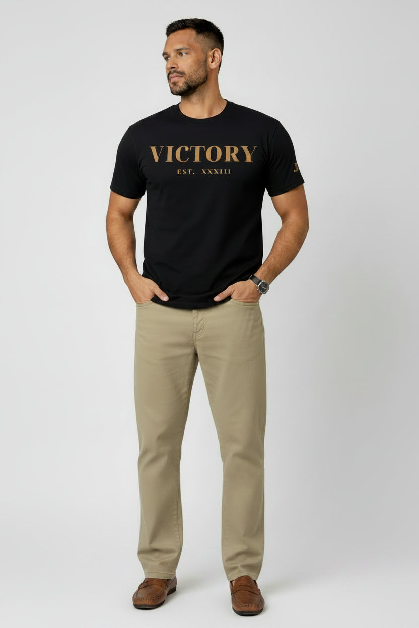 Man wearing a black t-shirt with 'VICTORY EST. XXXIII' text on a white background